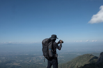 hikers traveling with backpacks taking pictures on the top of the mountain