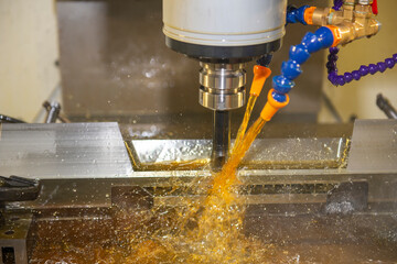 The CNC milling machine cutting the  mold parts with oil coolant method.