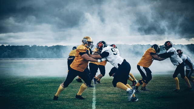 American Football Stadium. Two teams with Professional Players, Fight for Ball and Score, Aggressive Face-off, Tackle, Pass. Warrior Competition Full of Brutal Energy, Power, Skill.
