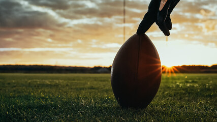 American Football Kickoff Game Start. Close-up Shot of an American Ball Standing on a Grass Field...