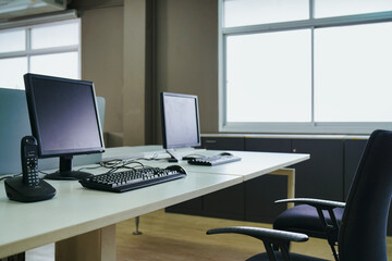 Empty business office computer screen and keyboard desktop telephone on table