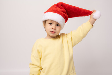 Cute little boy wearing santa hat isolated over white background.