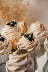 Cakes with creamy white cream and blueberries, top view, close-up, mirrored