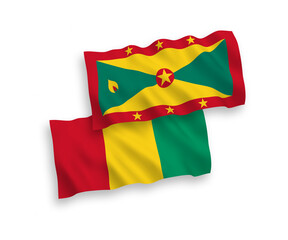 National vector fabric wave flags of Grenada and Guinea isolated on white background. 1 to 2 proportion.