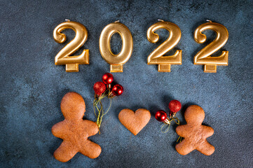 Homemade gingerbread cookies on dark background. Christmas composition, new year background. Number 2022 with cookies. Christmas dessert. New Year flatlay.