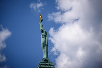 Fototapeta premium RIGA, LATVIA. 2nd July 2021. Selective focus photo. Monument of Freedom between clouds.