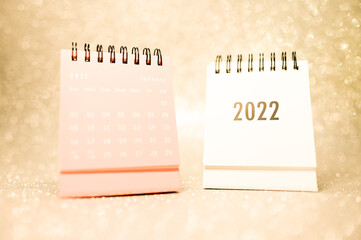 Two Calendars 2022 on gold background concept for new year