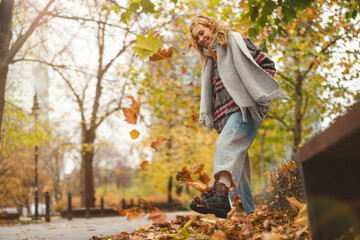 Happy young woman in autumn park
