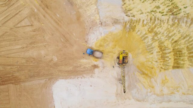 Sand quarry, Aerial shot. Dragline and dumptruck in working proccess