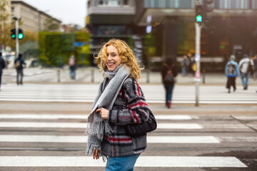 Young woman on a crosswalk in Warsaw, Poland
