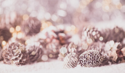 Christmas themed background-multiple exposure snowy pine cones and golden glitter