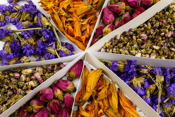 Dry flower tea of ​​different types in a box, background
