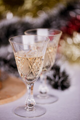 Christmas themed background-two glasses of champagne on a christmas decorated table