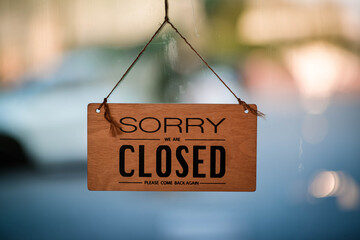 hangging wooden sign sorry we are closed please come back again,