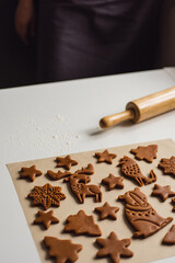 Pattern of Christmas gingerbread cookies in the form of animals, trees, snowflakes
