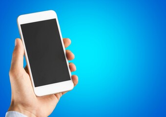 Human hand holding a phone with a blank screen