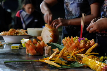 hands of a person designed floating offering  with flowers decorations for Loy Kratong festival of lights in Thailand.