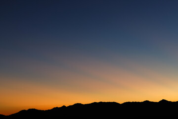 Heaven at early morning with copy space. Sunset, sunrise backdrop.Predawn clear sky with orange horizon and blue atmosphere. Smooth orange blue gradient of dawn sky.