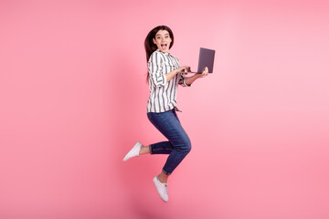 Fototapeta na wymiar Full body profile side photo of excited girl jump use laptop agent manager isolated over pink color background