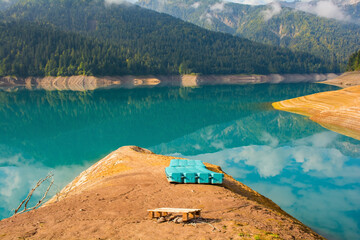 Low water in Sauris Lake, Lago di Sauris, in late September. The blue floats are where water...
