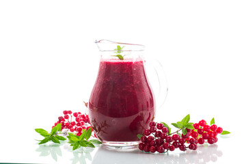 freshly squeezed thick natural juice with pulp from ripe red viburnum in a decanter
