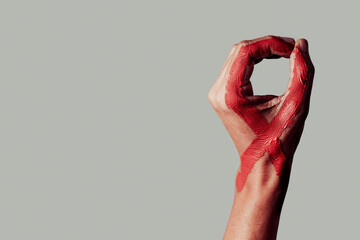 red ribbon for the fight against AIDS in his hand