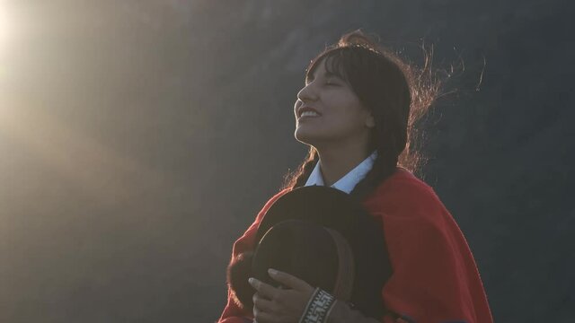 Content Peruvian woman smiling while enjoying nature in sunlight