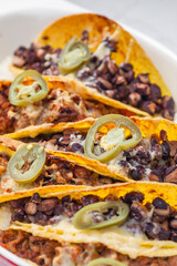 tacos filled with minced meat and black beans