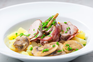 veal roll in bacon with mushroom sauce and potatoes