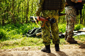 a soldier shoots an RPG. training shooting from a rocket launcher at a military training ground. a...