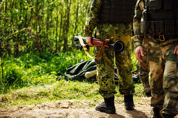 a soldier shoots an RPG. training shooting from a rocket launcher at a military training ground. a...