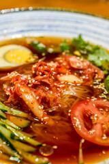 Closeup of a bowl of delicious cold Korean noodles