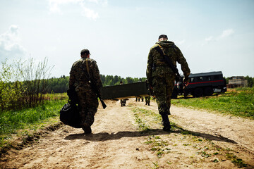 soldiers carry boxes of ammunition and ammunition in their hands