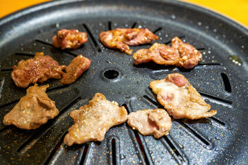 Close-up of grilled pork belly on Korean barbecue grill pan