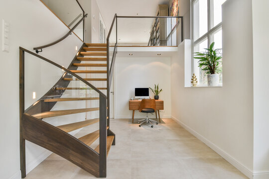 Interior light room with workplace and stairs in contemporary house