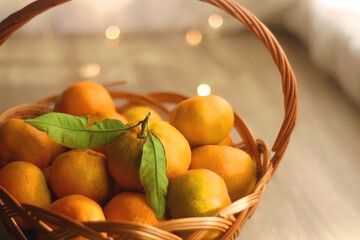 Vintage basket filled with fresh tangerines. Bokeh lights in the background. Selective focus.