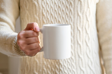 female hand holding white mug with blank copy space scree for your advertising text message or...