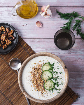 Bowl with soup tarator placed on table