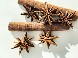 Aroma anise stars and cinnamon sticks isolated on white background. Top view. Christmas spices.
