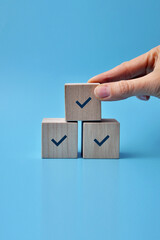 Wooden blocks with drawings of checkmarks. A symbol of consent and correct choice