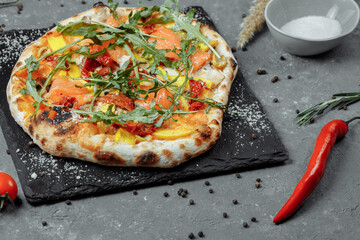 Delicious pizza with salmon and vegetables. italian pizza