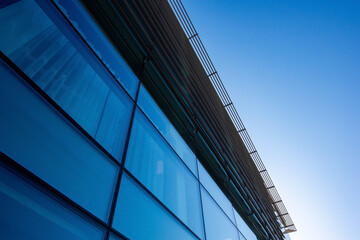 Fototapeta na wymiar Modern glass architecture of office building against the sky from below 