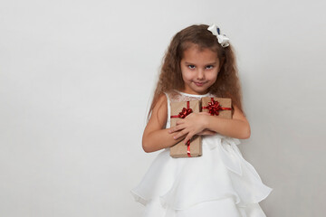 Child girl with christmas gift box on a white background