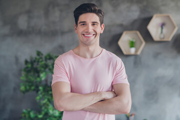 Fototapeta premium Photo of handsome self-assured positive guy crossed hands wear casual outfit in comfortable apartment home indoors