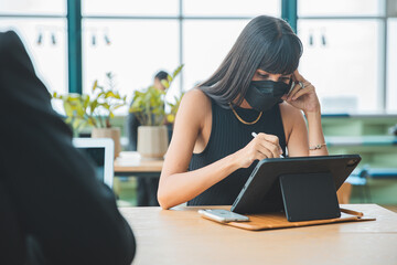 Business people with face masks back at work or school in office after lockdown. Businessman work via smart phone social distance online. 