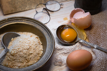 Flour and eggs on kitchen table - baking ingredients for baking bread