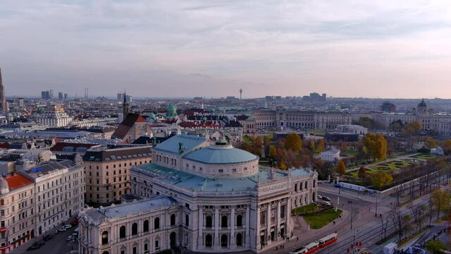 Elevated view of the Burgtheater The Burg in Vienna Austria ft beautiful aerial cityscape at dusk. Flying by worldwide famous historical landmark around Vienna&rsquo;s centre with street autumn scene 4K