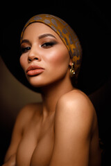 Closeup portrait of an elegant and beautiful african american young woman with perfect smooth glowing skin, full lips and fashionable makeup. Dark background. Studio shoot - 470896789