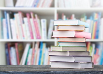 Stack of books on the table in the library background