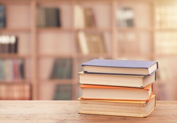 Stack of books on the table in the library background